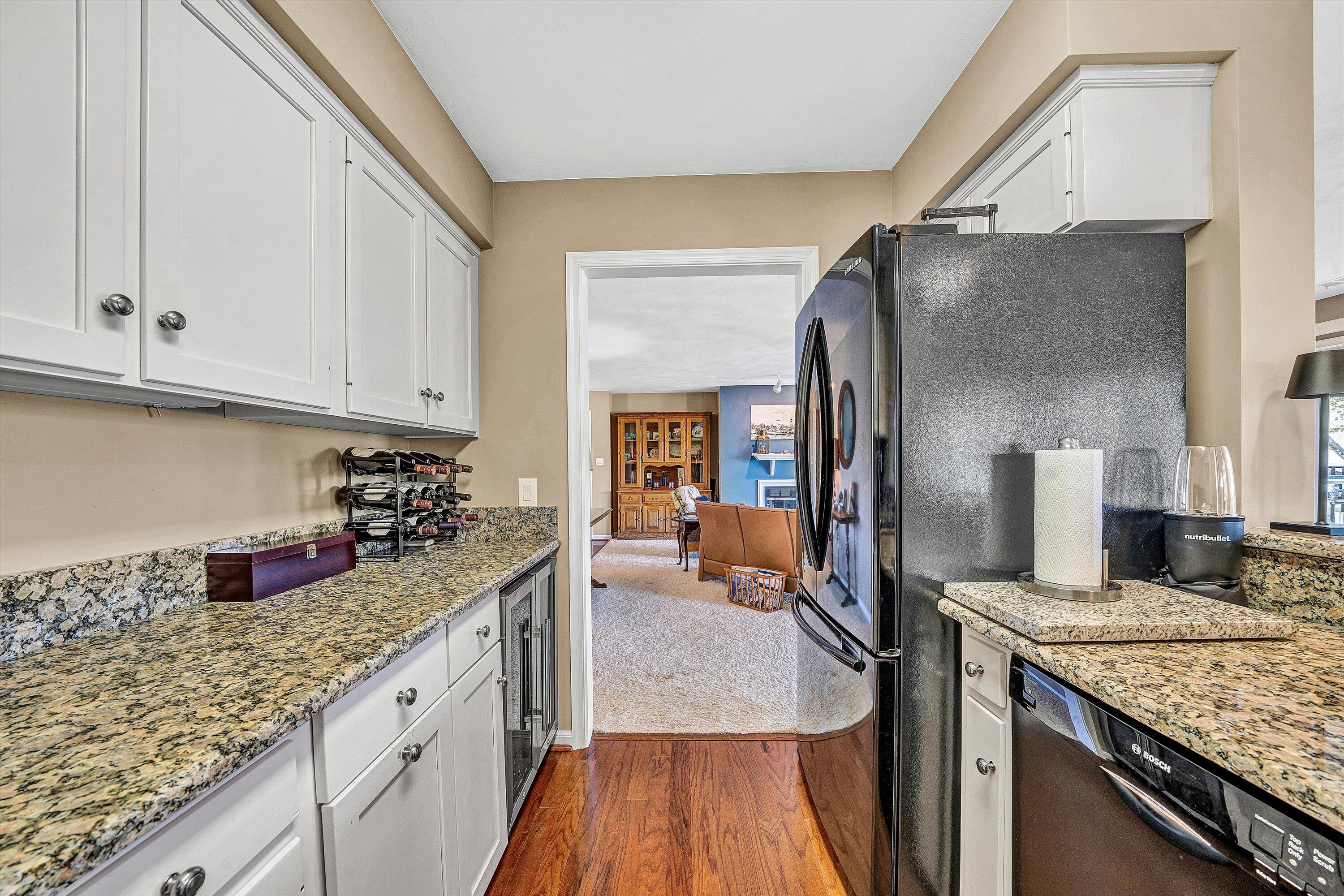 410 Marina Bay Drive, Unit 102 Penhook, VA 24137 - Photo 17 of 38 a kitchen with granite countertop a sink stove and cabinets