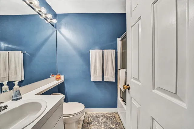 a bathroom with a sink toilet and mirror