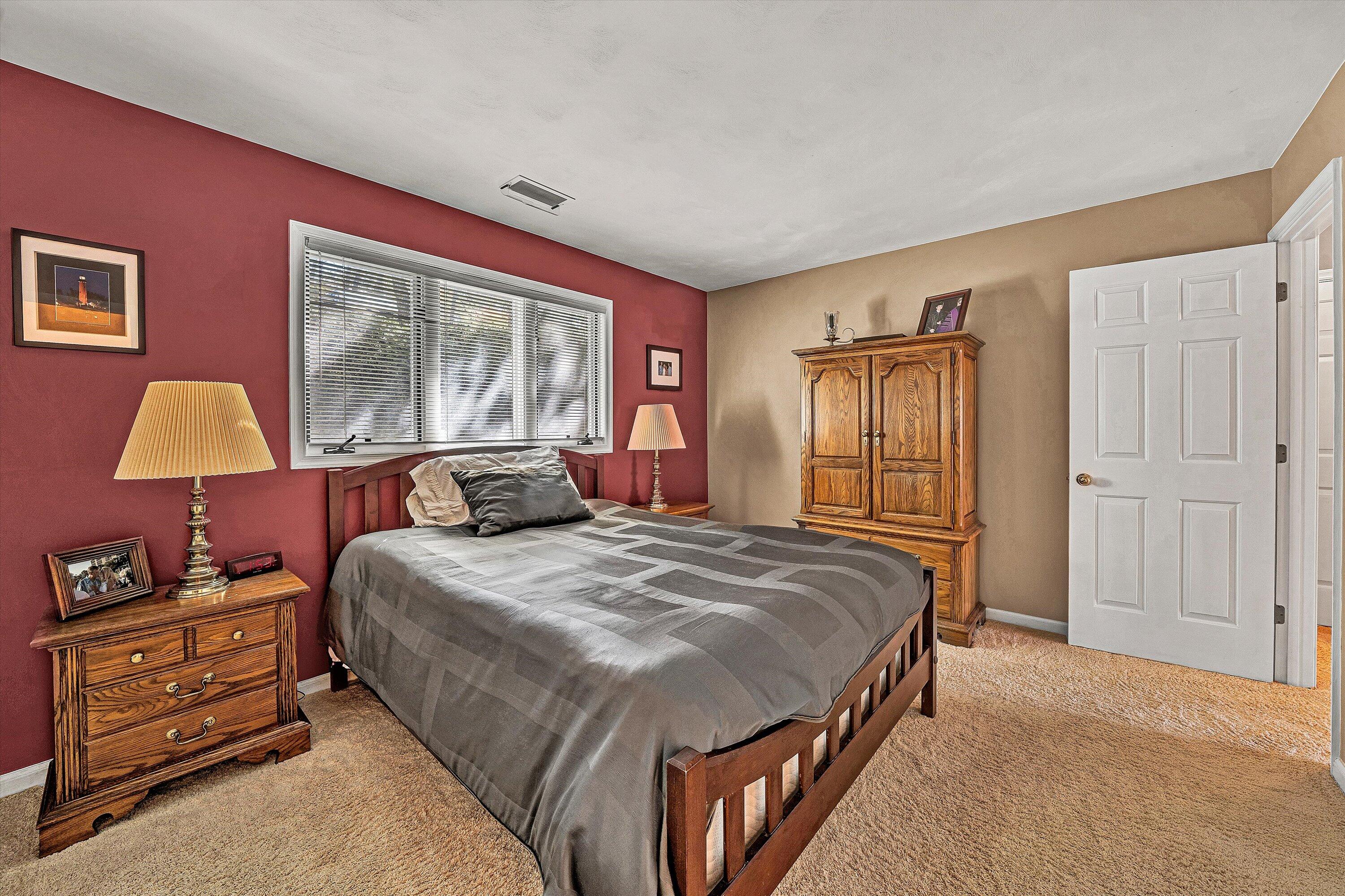 410 Marina Bay Drive, Unit 102 Penhook, VA 24137 - Photo 21 of 38 a bedroom with a bed and wooden floor