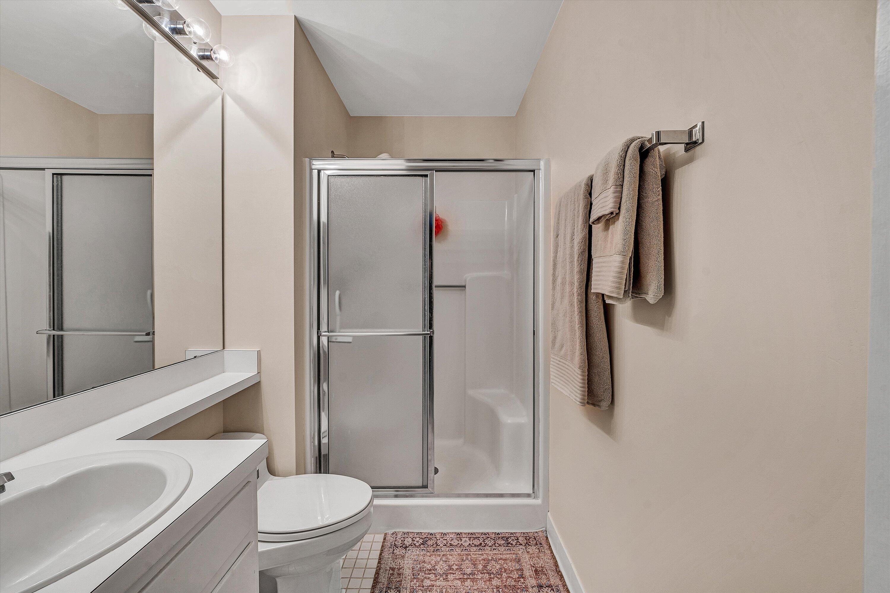 410 Marina Bay Drive, Unit 102 Penhook, VA 24137 - Photo 22 of 38 a bathroom with a shower a toilet and a sink