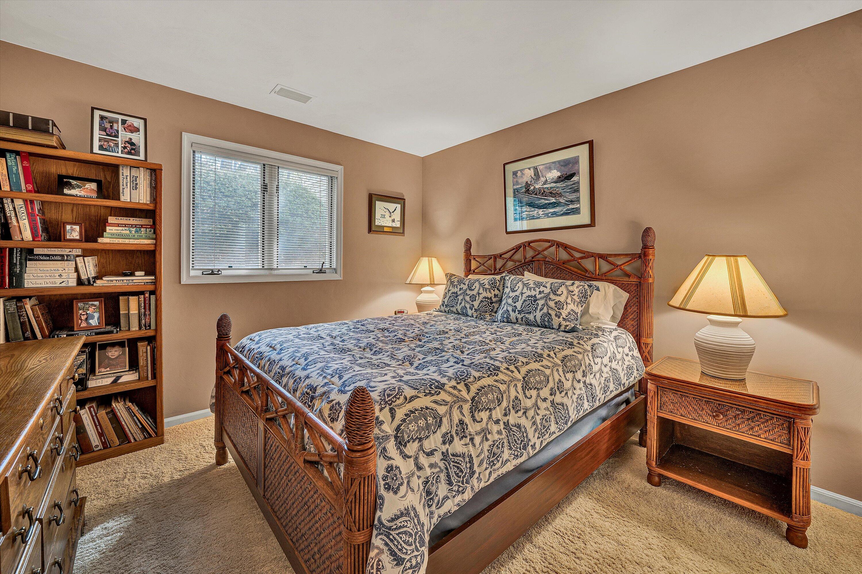 410 Marina Bay Drive, Unit 102 Penhook, VA 24137 - Photo 23 of 38 a bedroom with a bed and a book shelf