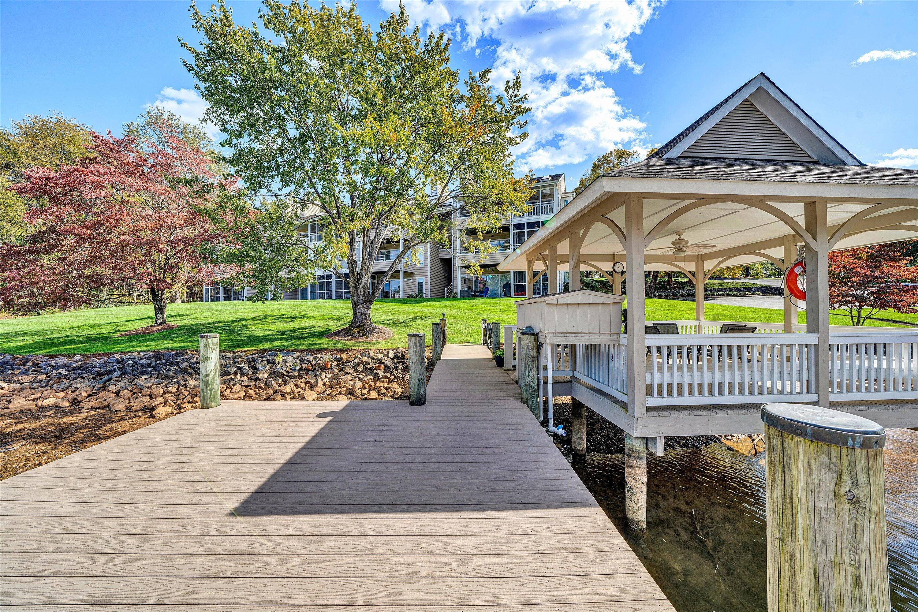 410 Marina Bay Drive, Unit 102 Penhook, VA 24137 - Photo 31 of 38 a view of a house with a yard