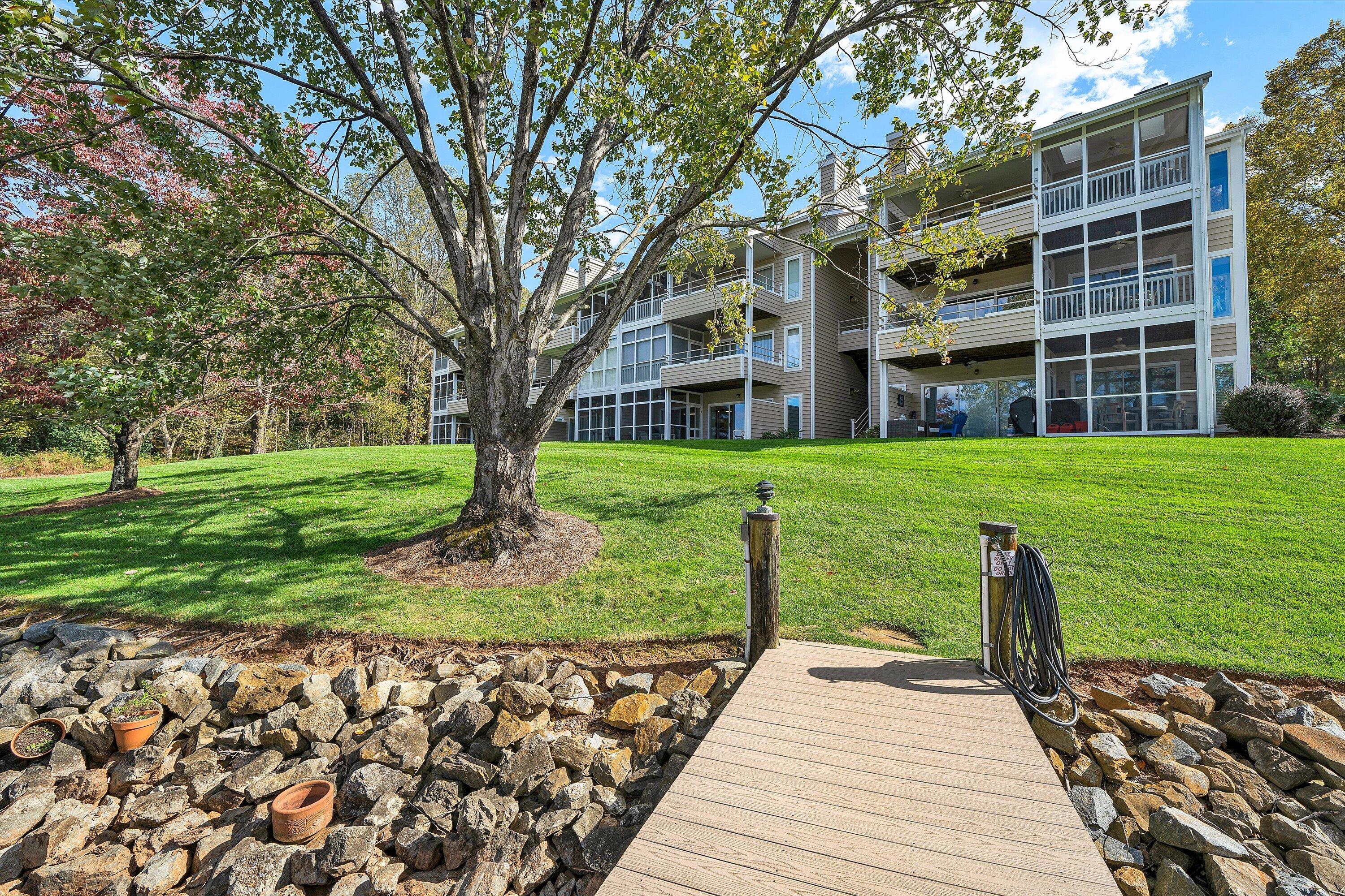 410 Marina Bay Drive, Unit 102 Penhook, VA 24137 - Photo 32 of 38 a front view of a house with a yard