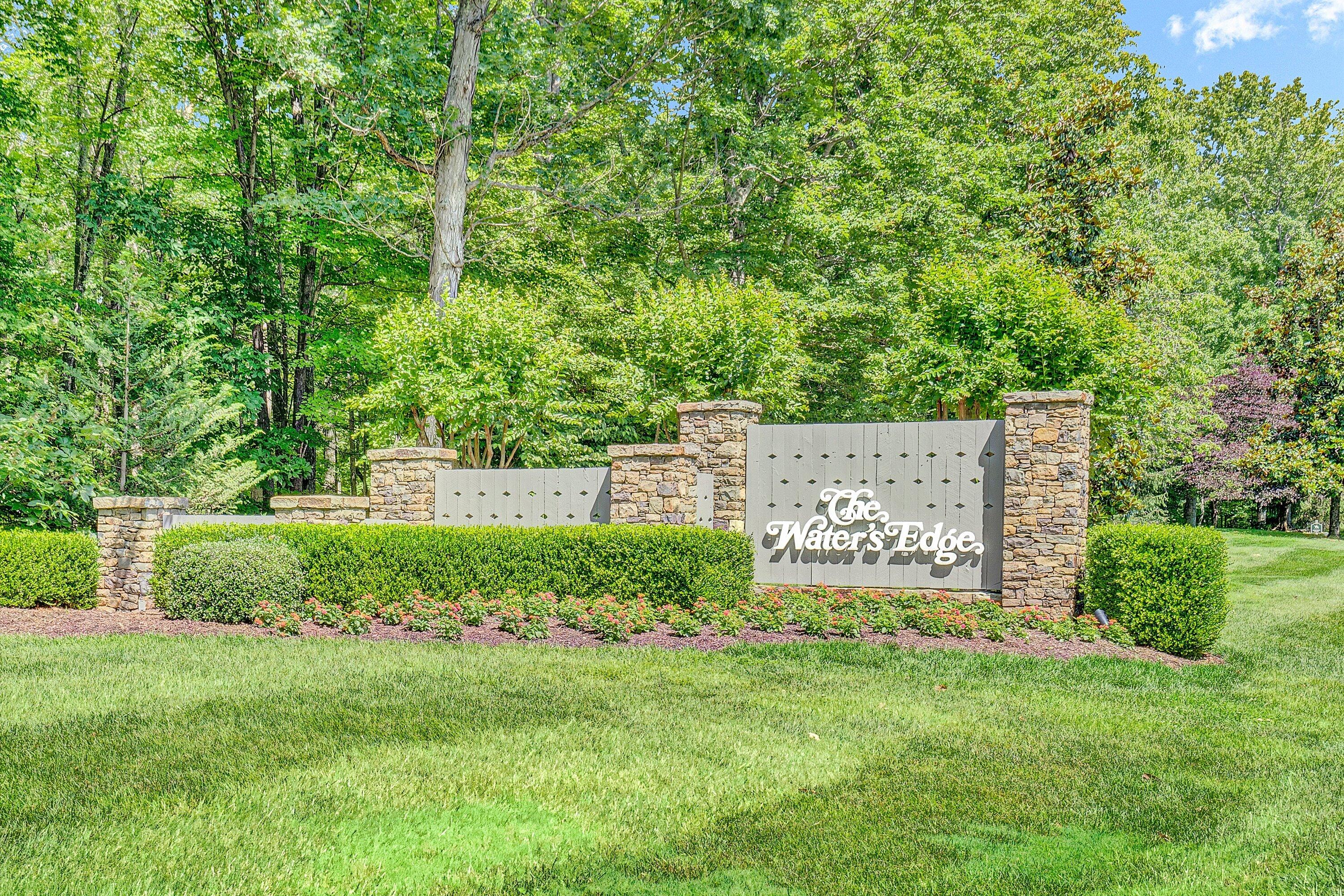 410 Marina Bay Drive, Unit 102 Penhook, VA 24137 - Photo 34 of 38 a sign of golf club on a wall under a tree