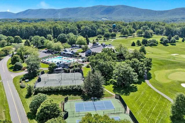 an aerial view of a houses with yard