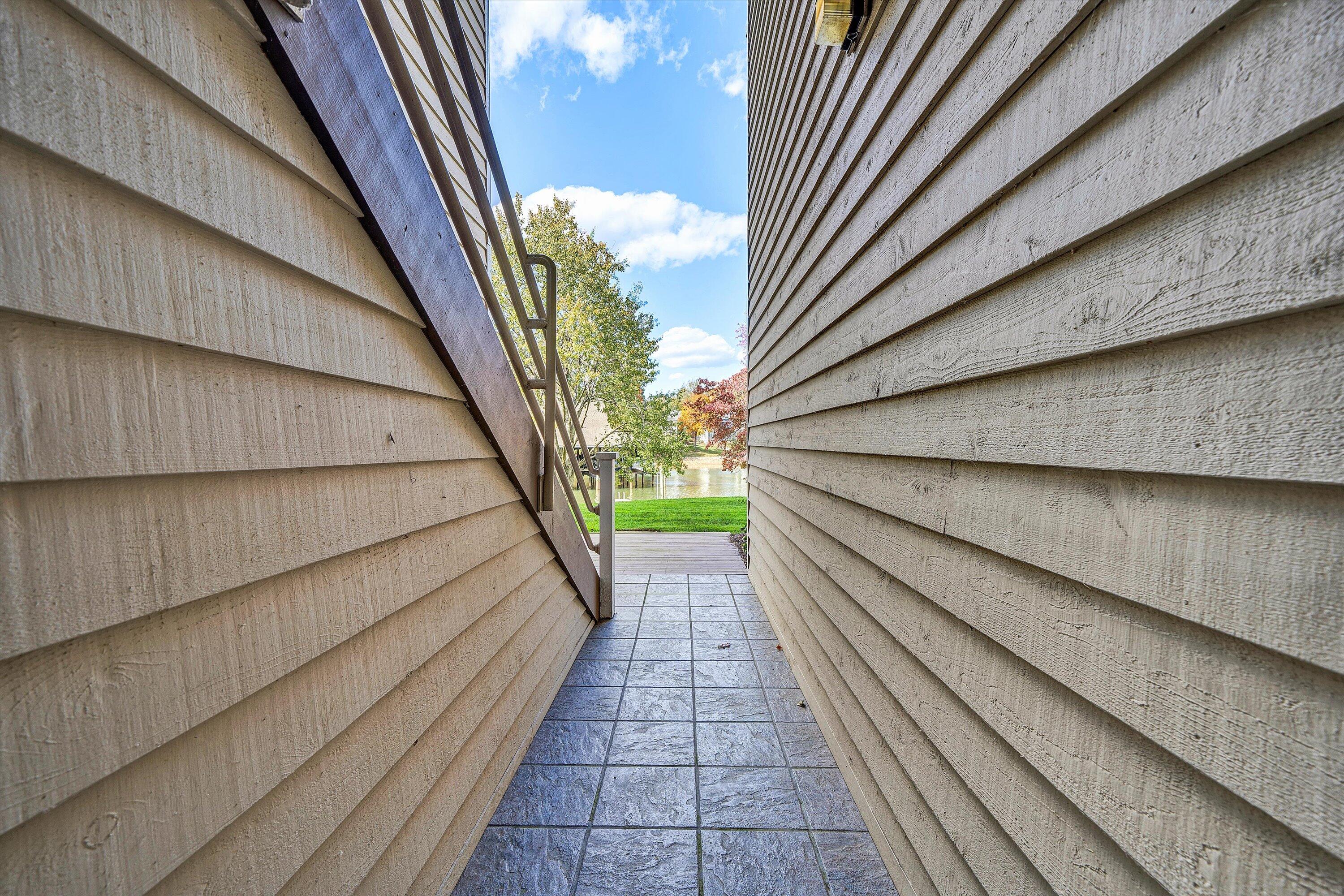 410 Marina Bay Drive, Unit 102 Penhook, VA 24137 - Photo 4 of 38 a balcony with stairs and a floor to ceiling window