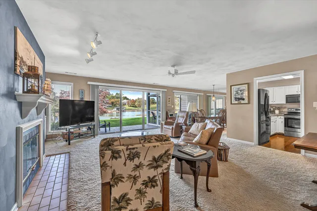 a living room with furniture a fireplace and a flat screen tv