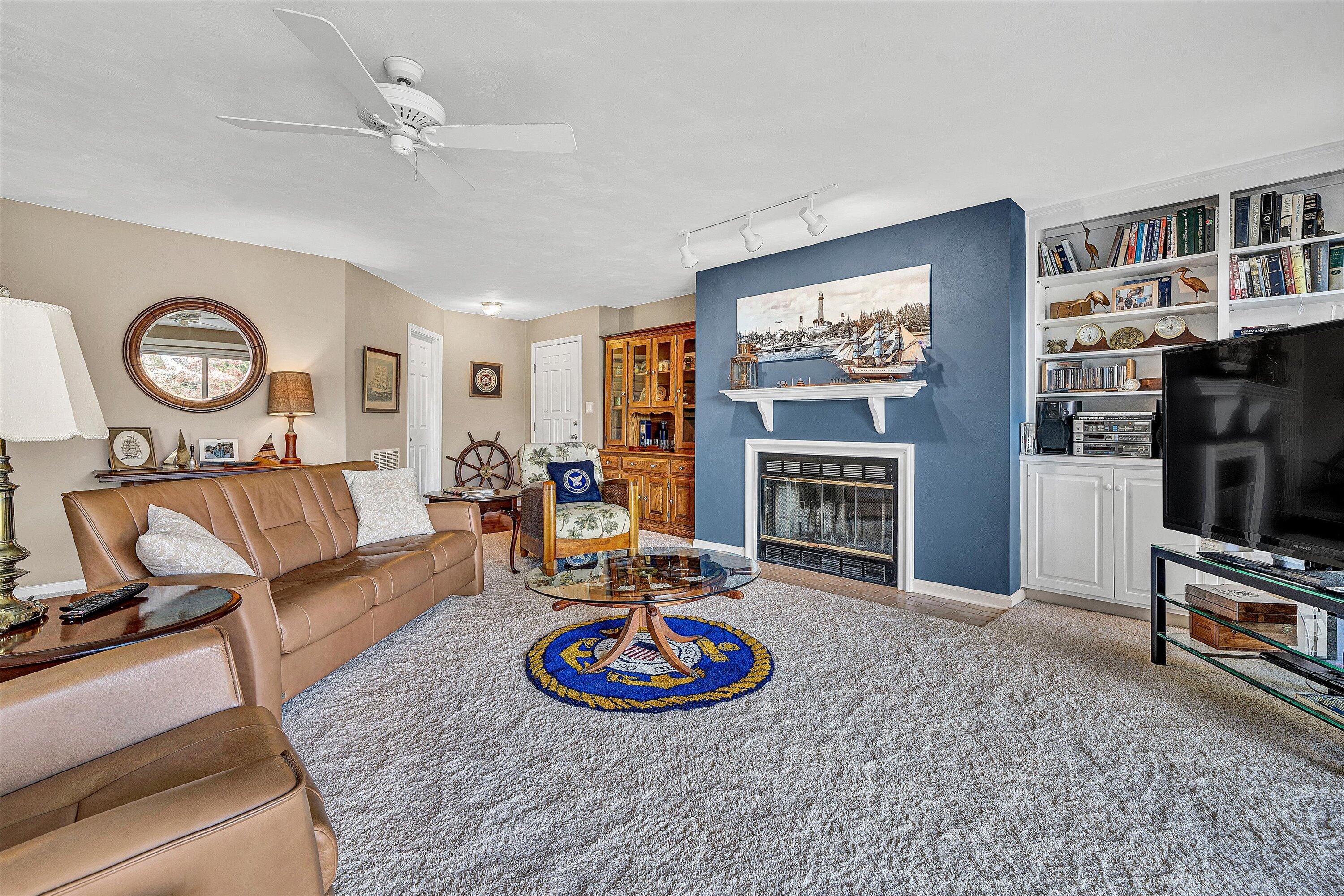 410 Marina Bay Drive, Unit 102 Penhook, VA 24137 - Photo 7 of 38 a living room with furniture a fireplace and a flat screen tv