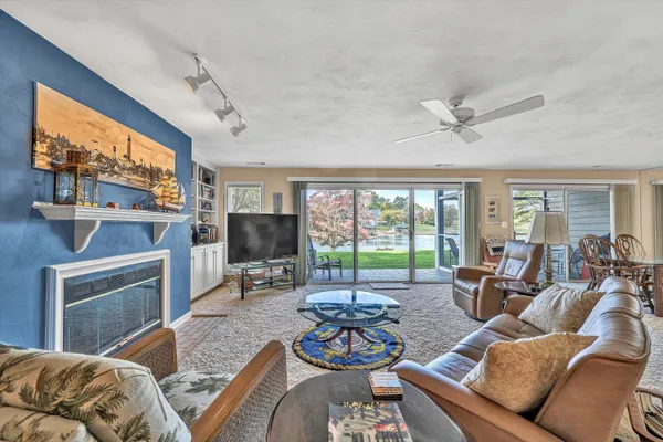 a living room with furniture a flat screen tv and a window