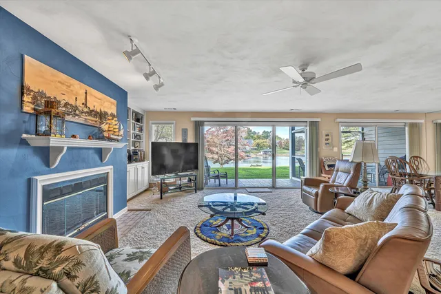 a living room with furniture a flat screen tv and a window