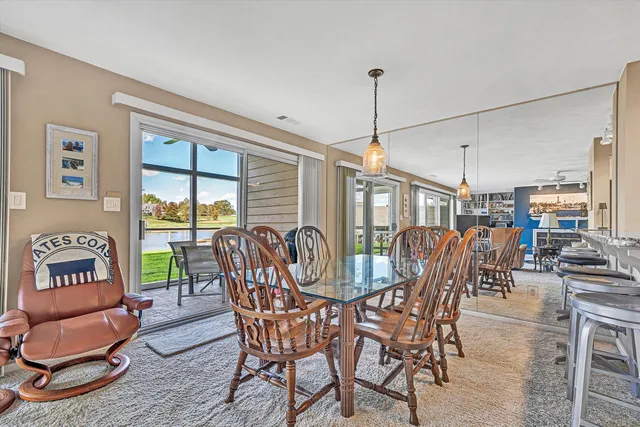 a view of a dining room with furniture and a chandelier