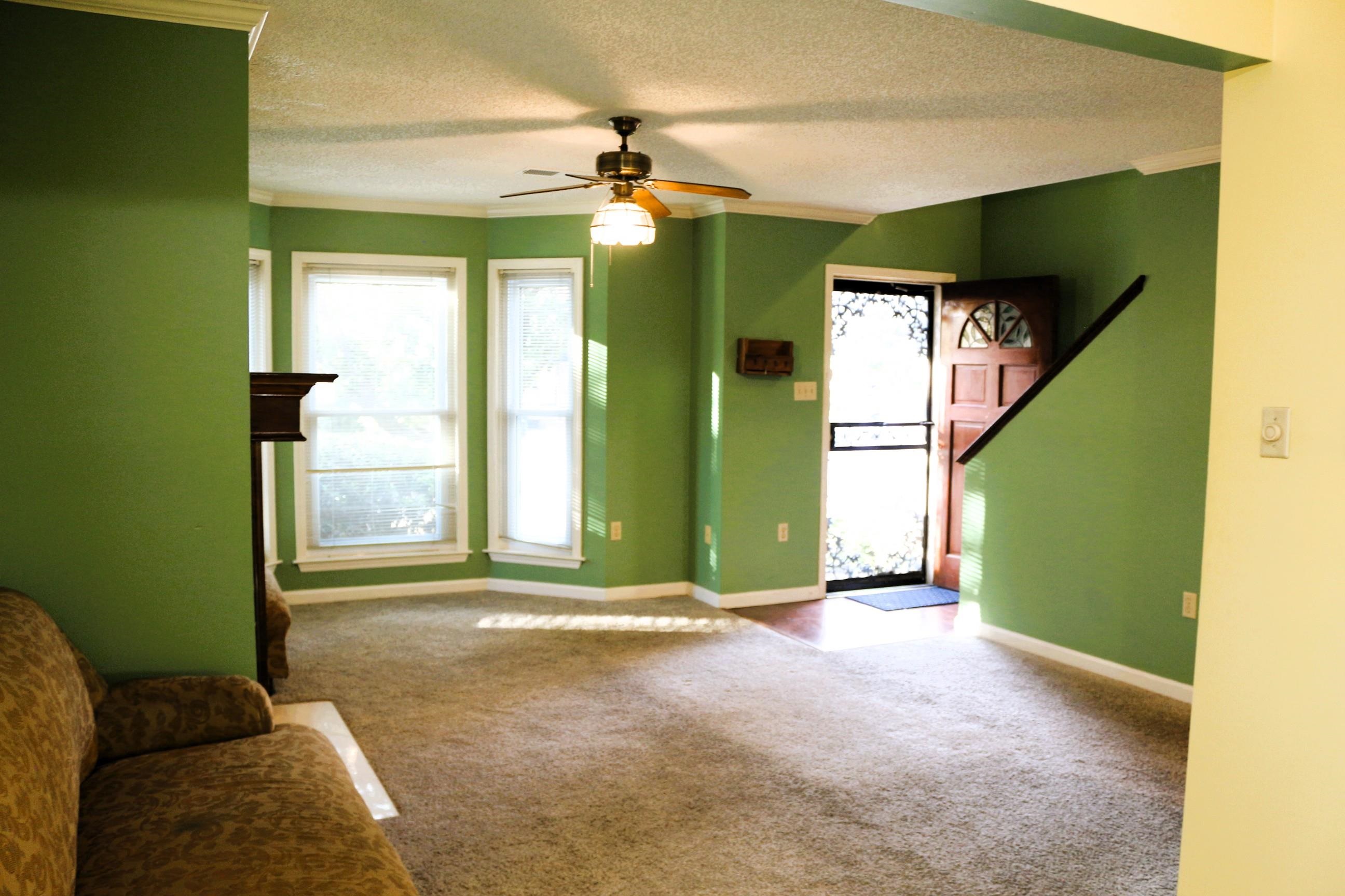 4204 Hickory Grove Road Memphis, TN 38141 - Photo 10 of 15 a living room with a mirror and a chandelier