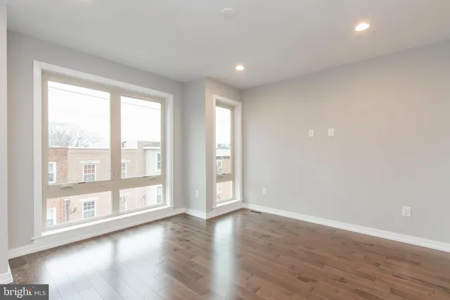 a view of a hallway with wooden floor