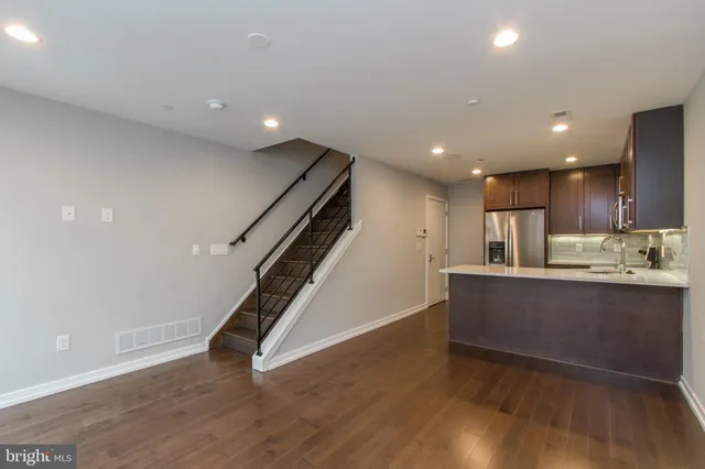 a view of kitchen with cabinets and wooden floor