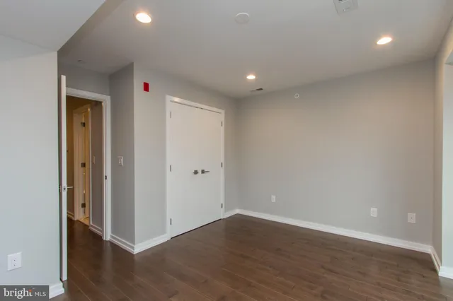 a view of an empty room with wooden floor