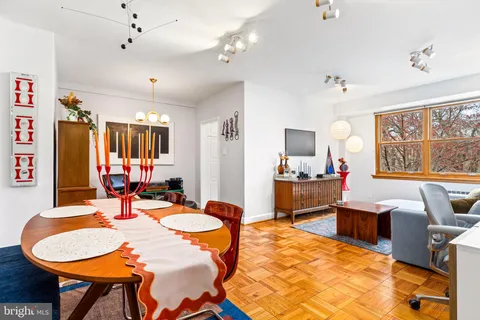 a dining room with furniture a window and a chandelier