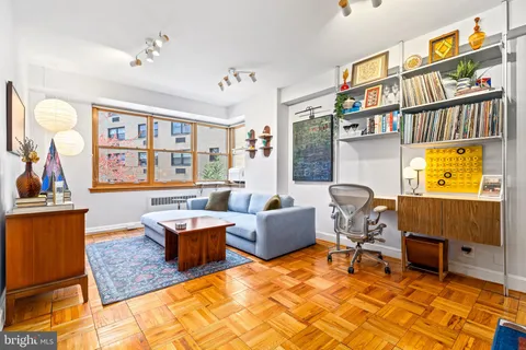 a living room with fireplace furniture and a window