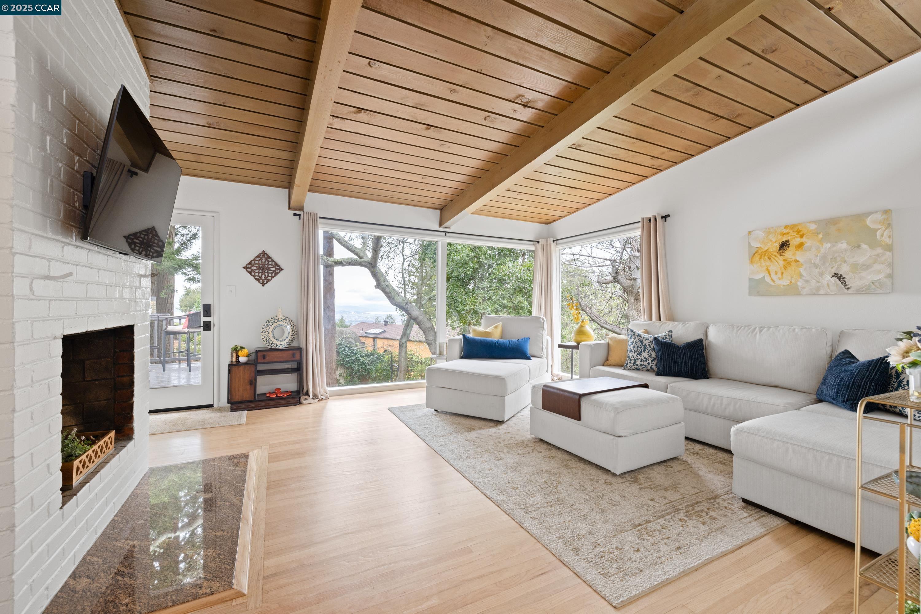 a living room with furniture large window and a fireplace