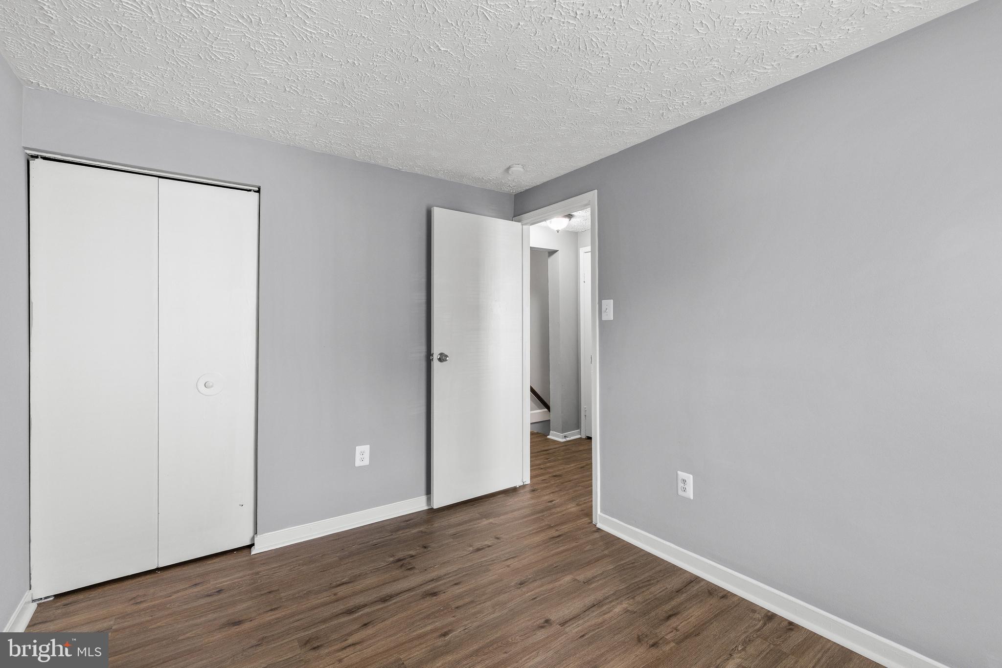 9479 Inaugural Drive King George, VA 22485 - Photo 19 of 26 a view of an empty room with wooden floor and closet