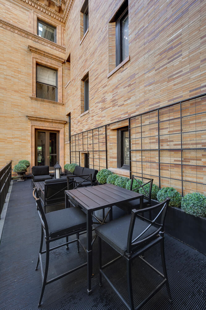1500 North Astor Street, Unit 6 Chicago, IL 60610 - Photo 33 of 39 a view of a patio with table and chairs and potted plants