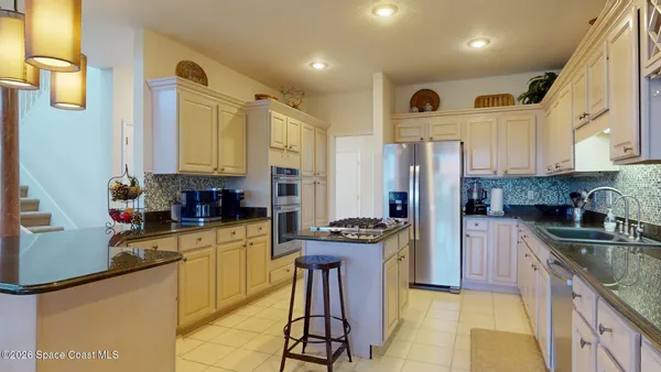 a kitchen with stainless steel appliances granite countertop a stove and a sink