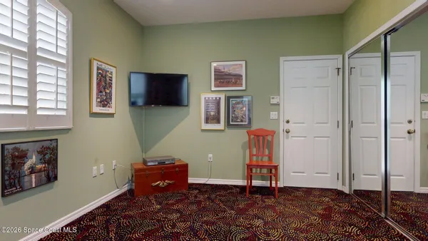a view of a hallway with bathroom and front door
