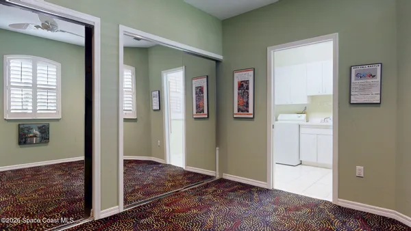 a white toilet sitting next to a bathroom sink and a mirror