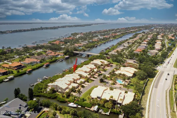 an aerial view of a house with a yard and garden