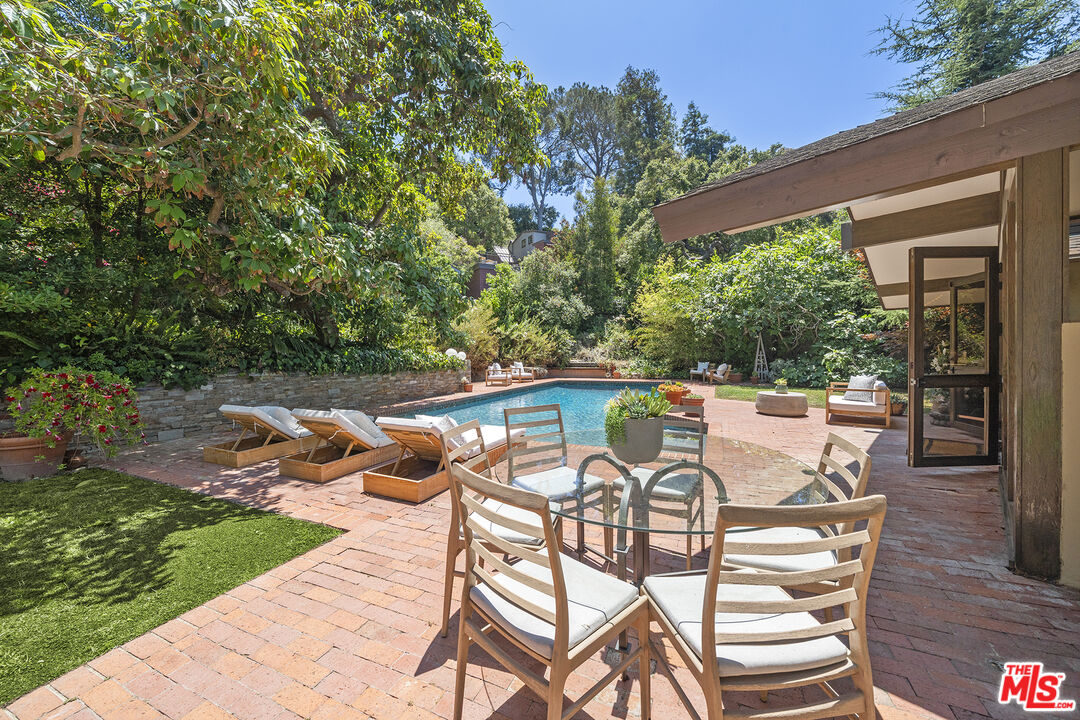 3 Latimer Road Santa Monica, CA 90402 - Photo 13 of 35 a view of a patio with table and chairs with wooden floor and fence