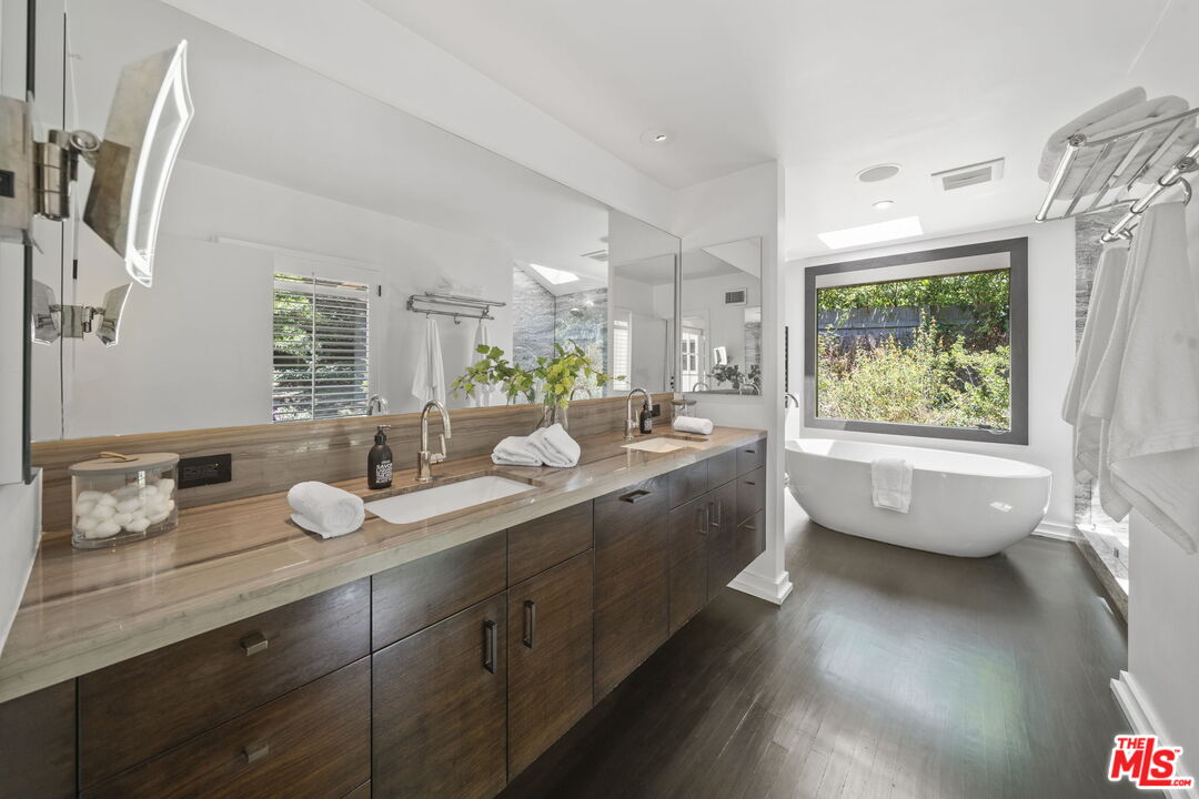 3 Latimer Road Santa Monica, CA 90402 - Photo 15 of 35 a bathroom with a granite countertop sink mirror bathtub and window
