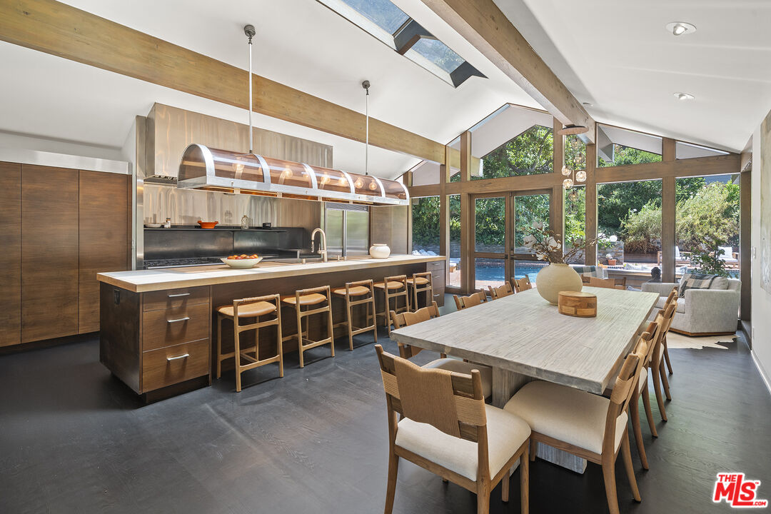 3 Latimer Road Santa Monica, CA 90402 - Photo 7 of 35 a kitchen with stainless steel appliances granite countertop a stove a kitchen island a table and chairs in it