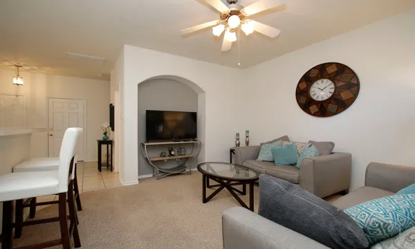 a living room with furniture and a flat screen tv