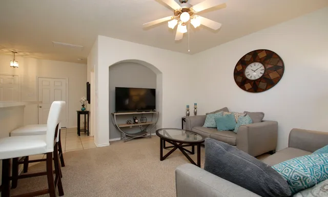 a living room with furniture and a flat screen tv