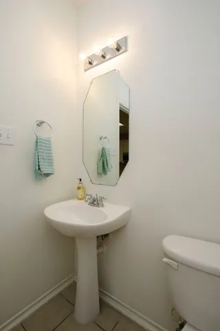 a bathroom with a sink toilet and mirror