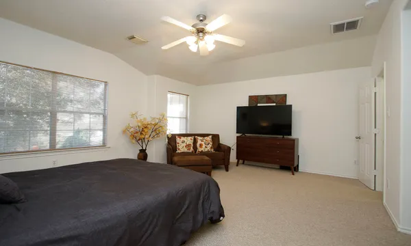 a bedroom with a bed and a couch