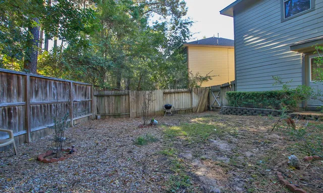 a backyard of a house with table and chairs