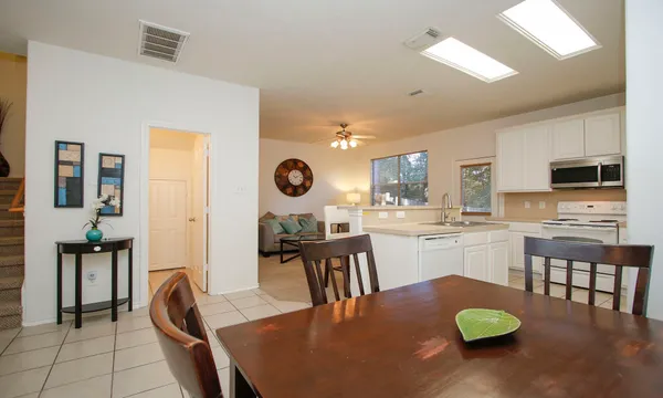 a kitchen with a table chairs and a refrigerator