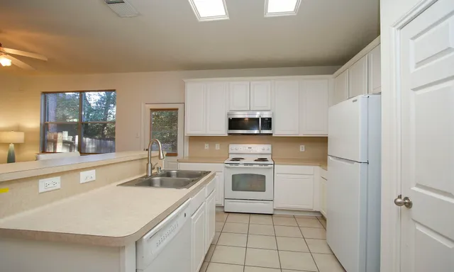 a kitchen with stainless steel appliances a stove sink and microwave