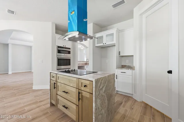 a spacious bathroom with a granite countertop sink a toilet a shower and a mirror