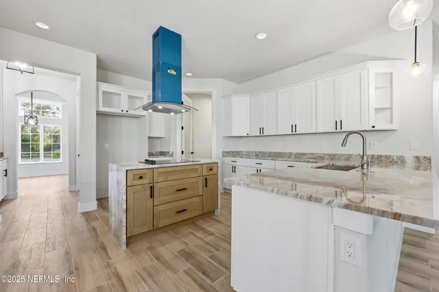 a large spacious bathroom with a granite countertop double vanity sink a mirror and a bathtub