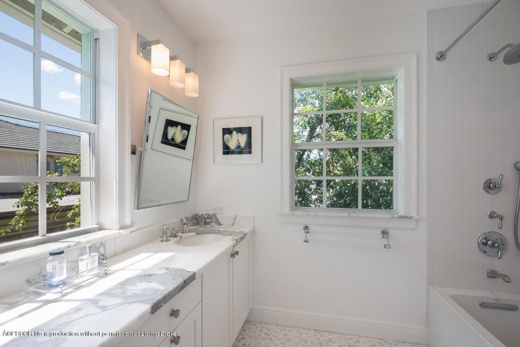 152 Reef Road Palm Beach, FL 33480 - Photo 22 of 25 a bathroom with a granite countertop sink mirror and a window