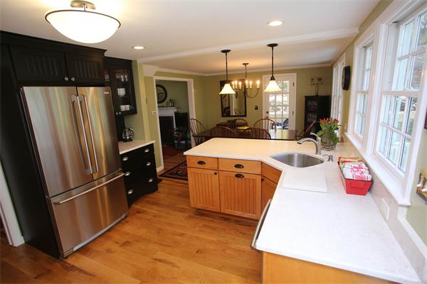 7 Sutherland Road Lexington, MA 02421 - Photo 12 of 22 a kitchen with stainless steel appliances granite countertop a refrigerator a sink dishwasher and a stove with wooden floor