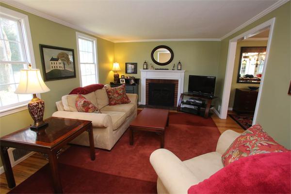 7 Sutherland Road Lexington, MA 02421 - Photo 15 of 22 a living room with furniture a fireplace and a flat screen tv