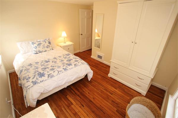 7 Sutherland Road Lexington, MA 02421 - Photo 19 of 22 a bedroom with a bed and wooden floor