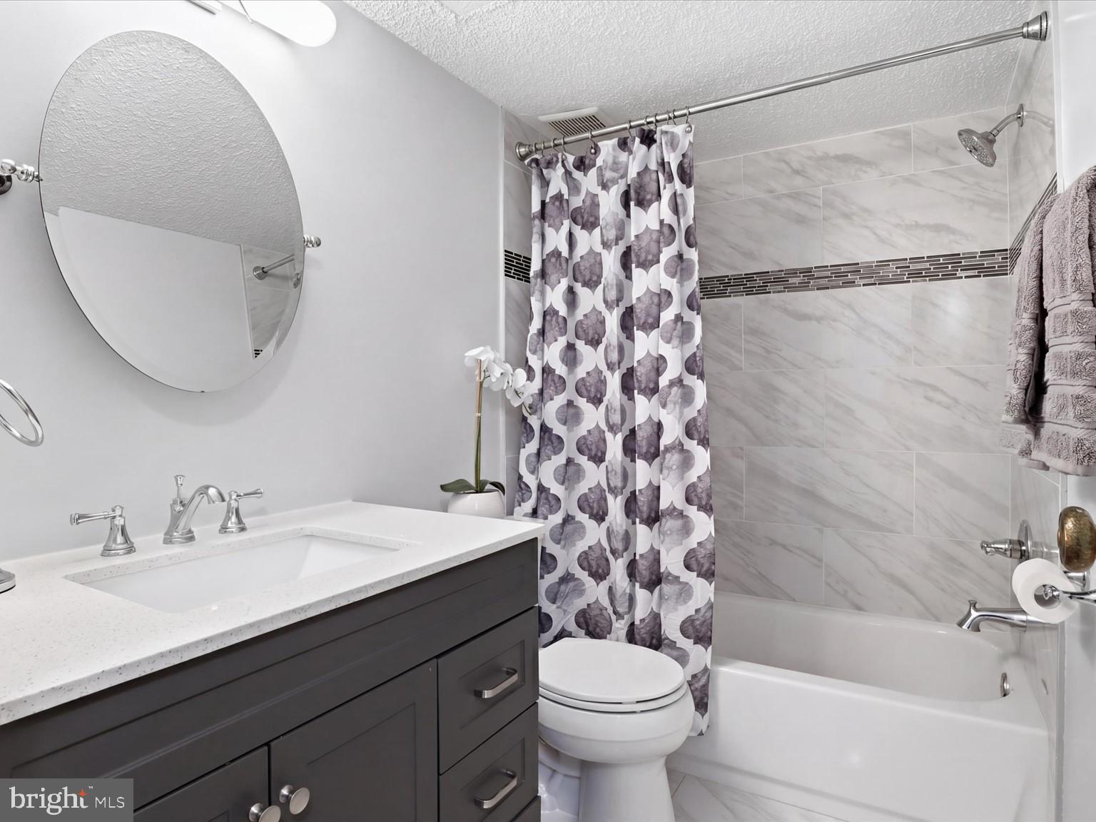 11809 Breton Court, Unit 2B Reston, VA 20191 - Photo 16 of 29 a bathroom with a sink a toilet and shower