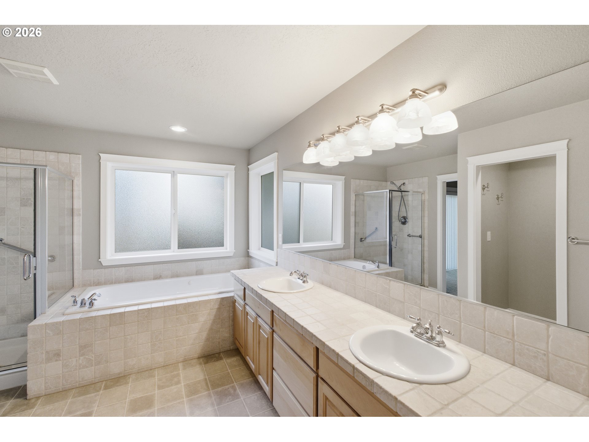 2463 Northwest Broadway Street Albany, OR 97321 - Photo 11 of 15 a bathroom with a tub sink and mirror