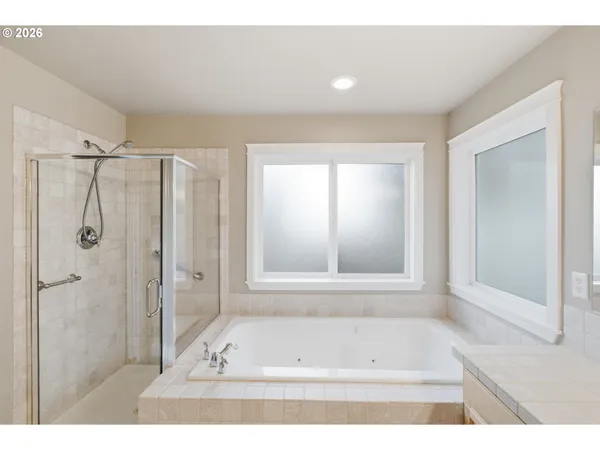a bathroom with a bathtub and a shower