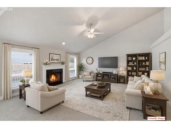a living room with furniture a fireplace and a flat screen tv