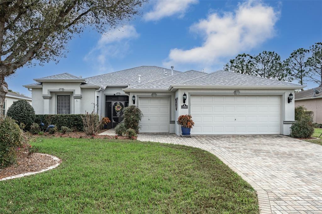15969 Southwest 14th Avenue Road Ocala, FL 34473 - Photo 1 of 46 a front view of a house with a yard