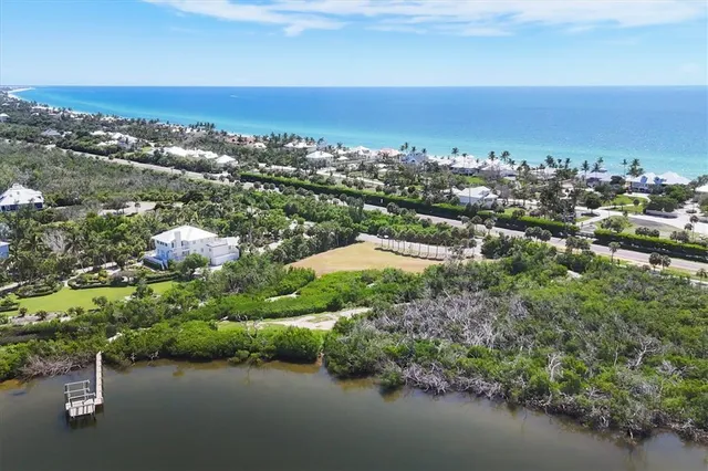 an aerial view of a houses with city and ocean view